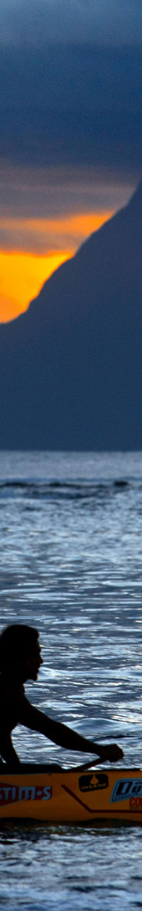 Silhouette of kayaker at sunset on ocean