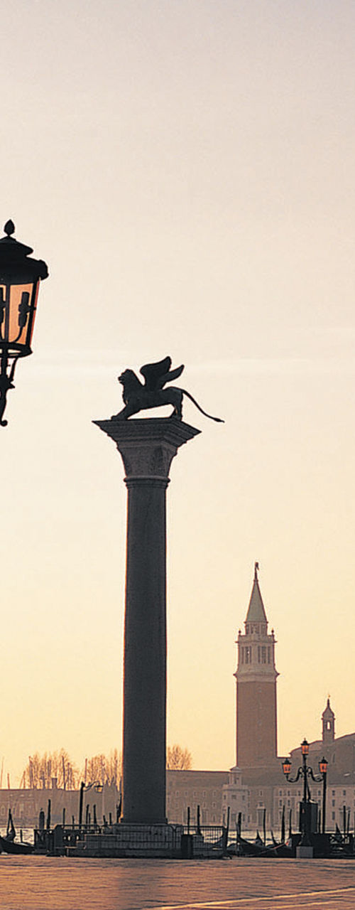 Venetian square at sunrise with landmarks