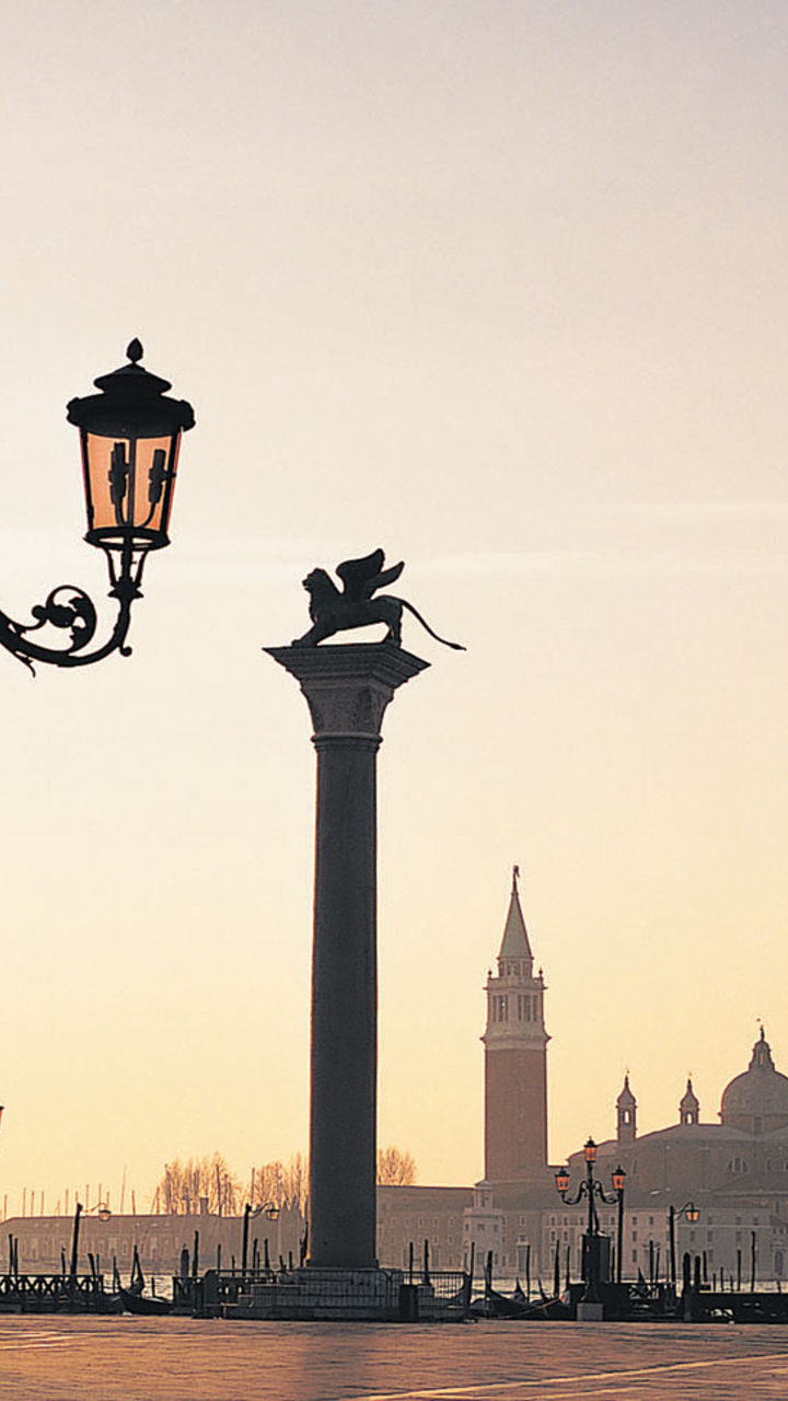Venetian square at sunrise with landmarks