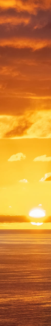 Golden sunset over calm ocean horizon