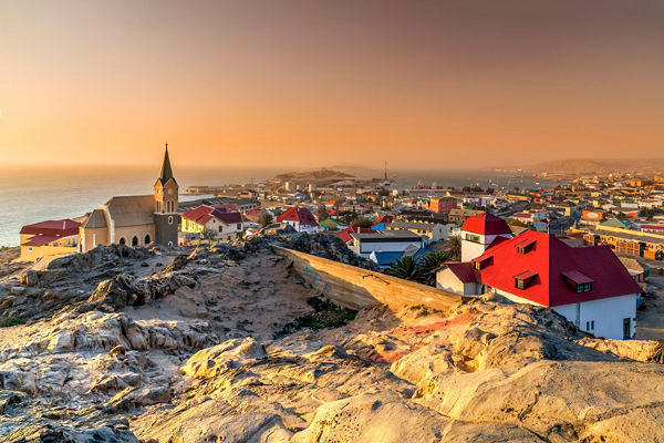 Scenic coastal town at sunset with church
