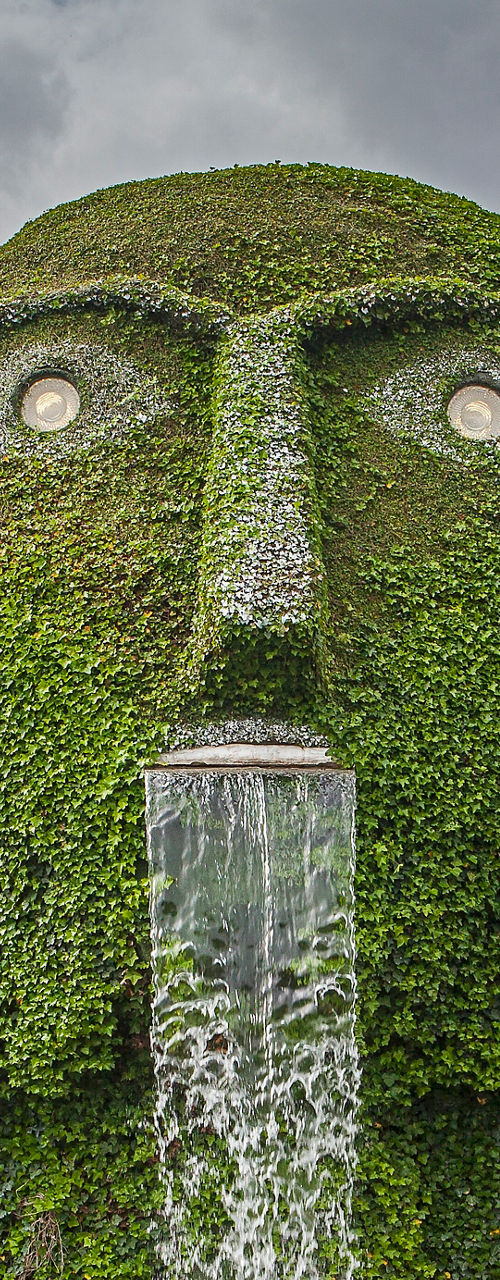 Giant green sculpture with waterfall feature