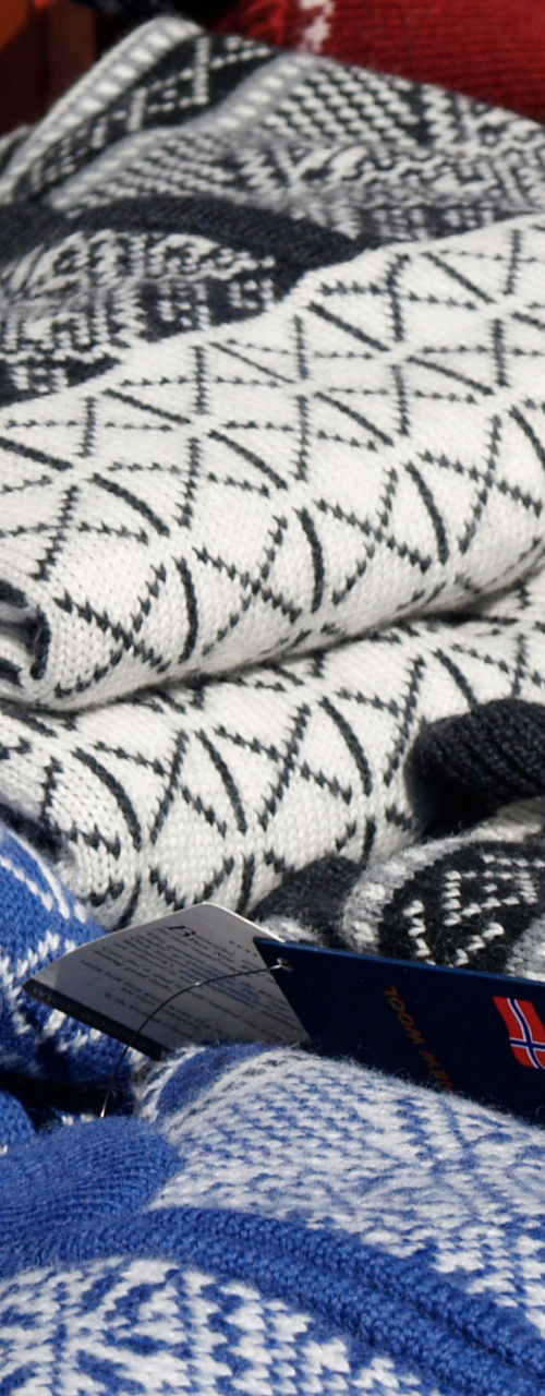Stack of Nordic-patterned knitwear in blue and white