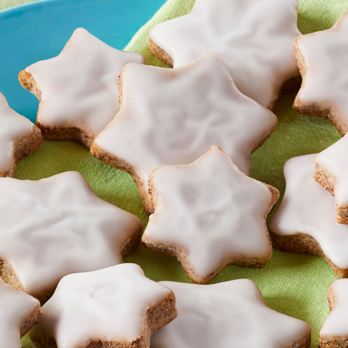 Star-shaped cookies with icing on plate