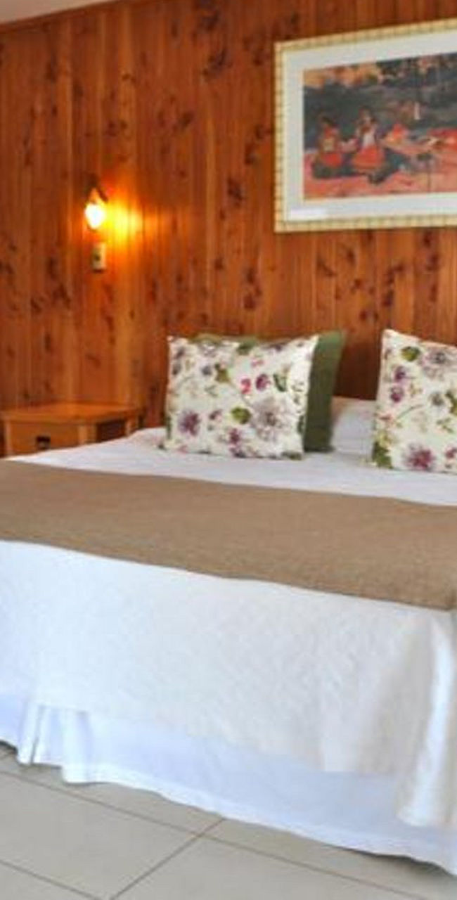 Cozy wooden bedroom with king-size bed