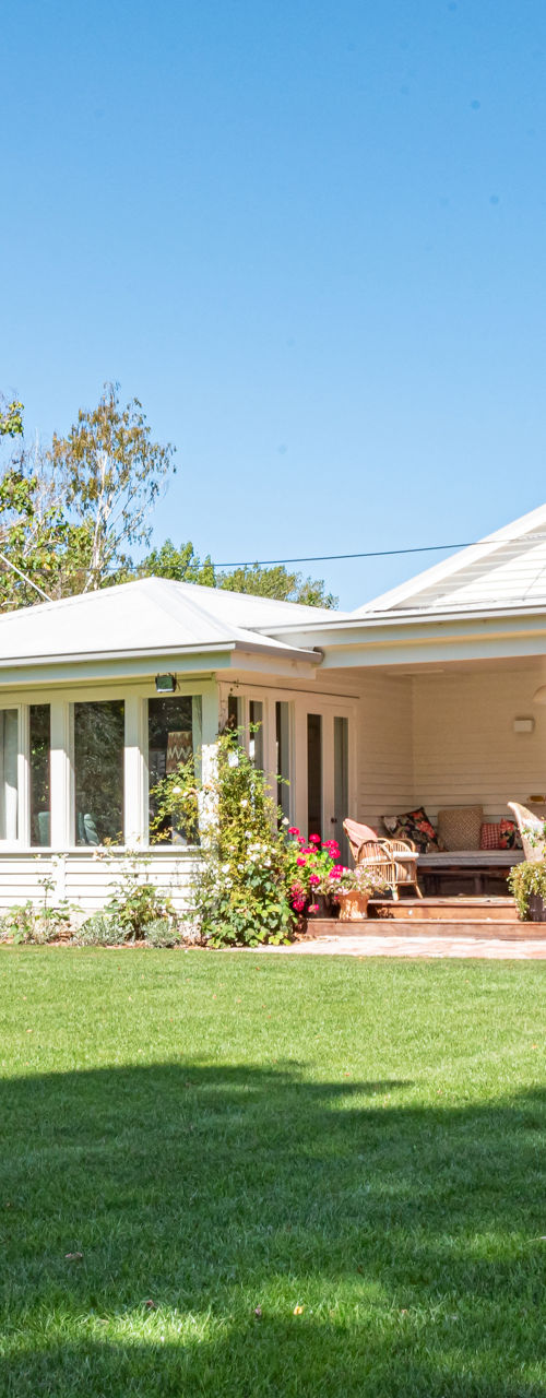 Sunny suburban house with large green lawn