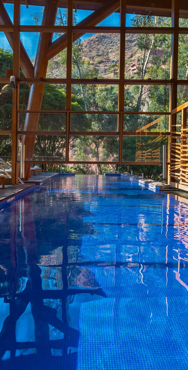 Indoor pool with wooden architecture and nature views