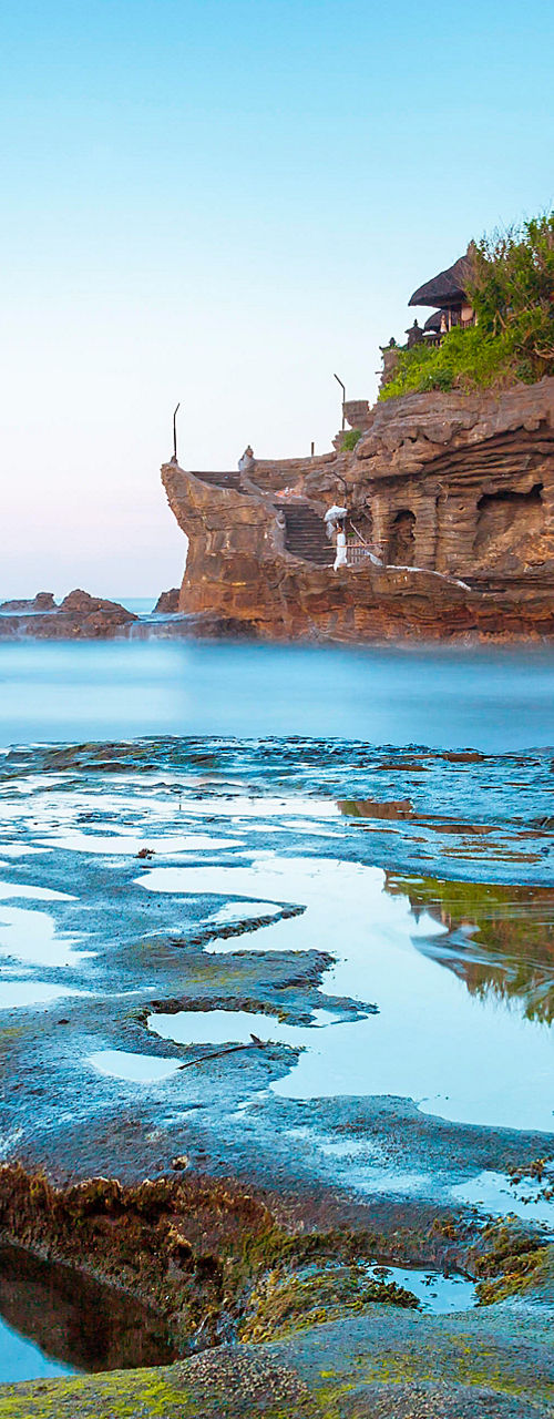 Tanah Lot temple on rocky coastal landscape