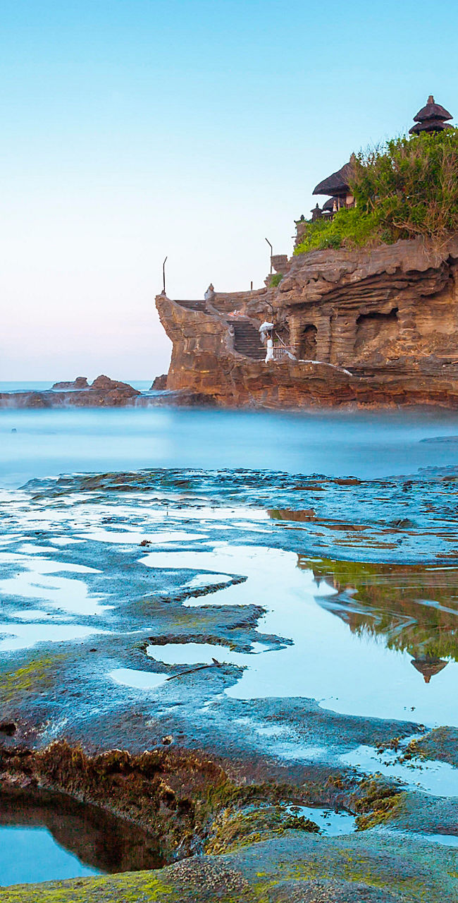 Tanah Lot temple on rocky coastal landscape