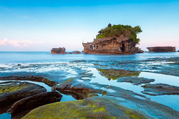 Tanah Lot temple on rocky coastal landscape