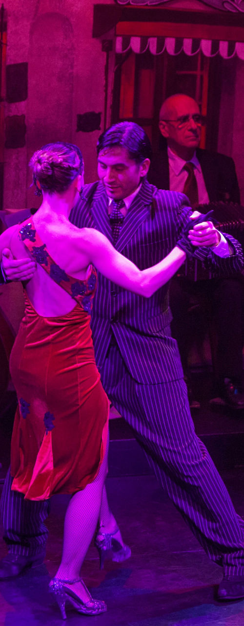 Tango dancers performing in vibrant setting