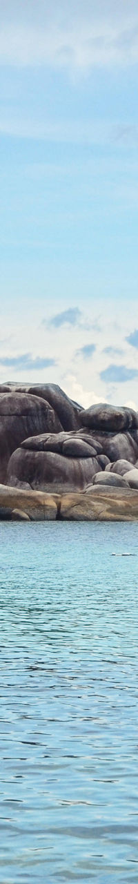 Scenic tropical beach with rocky shoreline