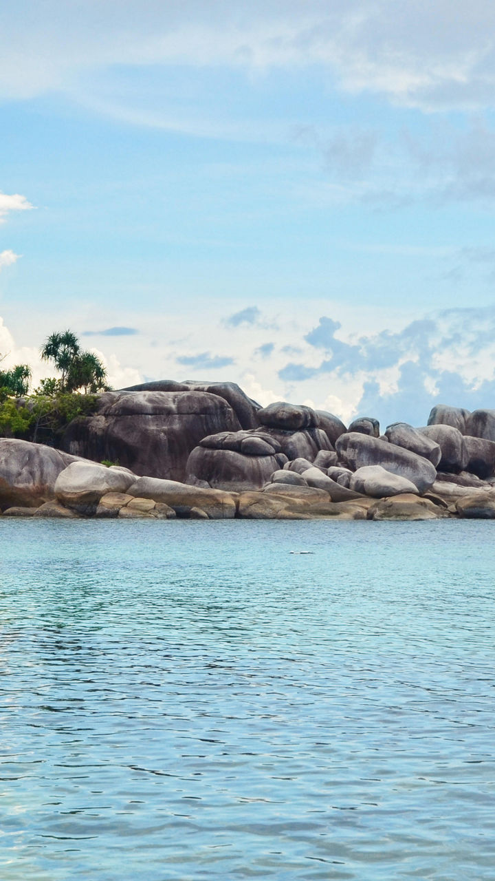 Scenic tropical beach with rocky shoreline