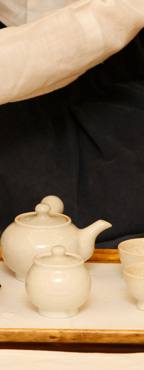 Traditional tea ceremony with white teaware