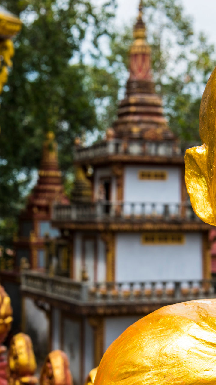 Golden Buddha statues in temple courtyard
