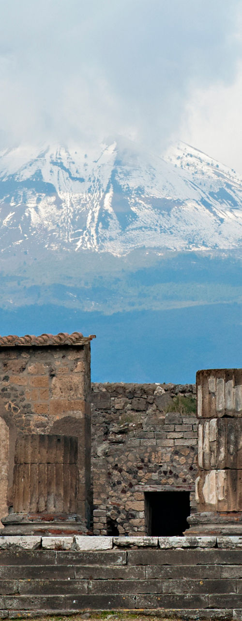 Ancient ruins with Mount Vesuvius backdrop