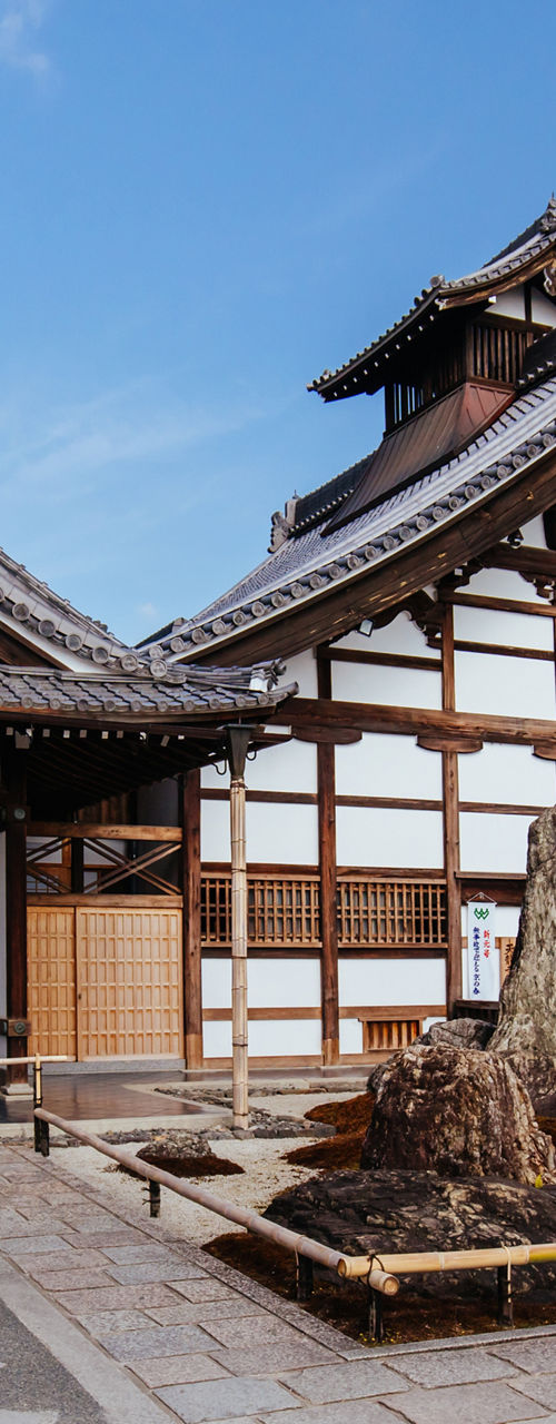 Traditional Japanese Temple with Courtyard and Blue Sky