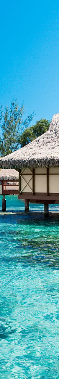 Tropical overwater bungalows in clear lagoon