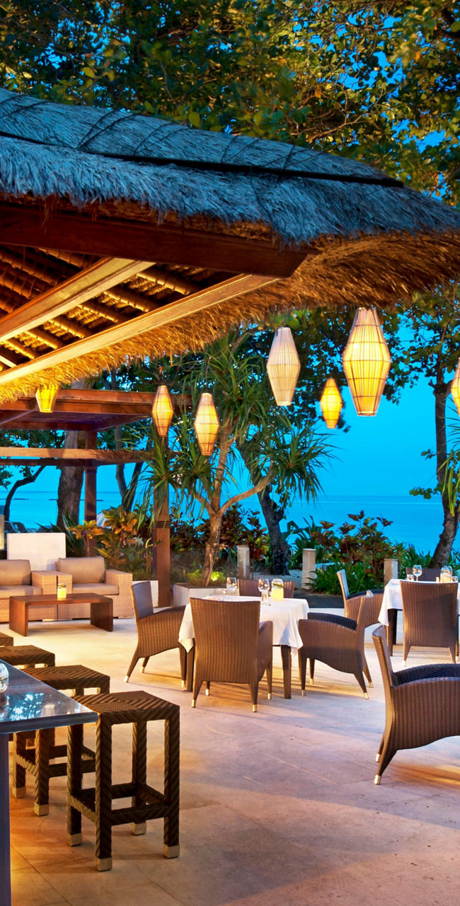 Outdoor tropical bar and dining area at dusk