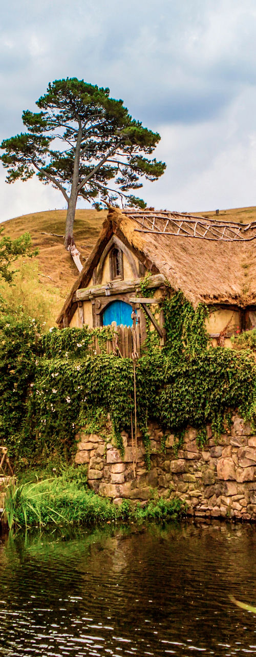 Rustic watermill by stone bridge in countryside