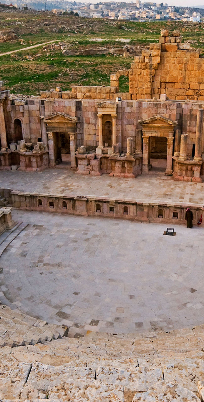 Ancient Roman amphitheater in scenic landscape