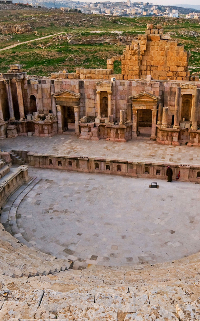 Ancient Roman amphitheater in scenic landscape