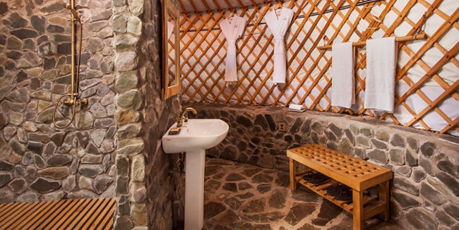 Rustic yurt bathroom with stone shower