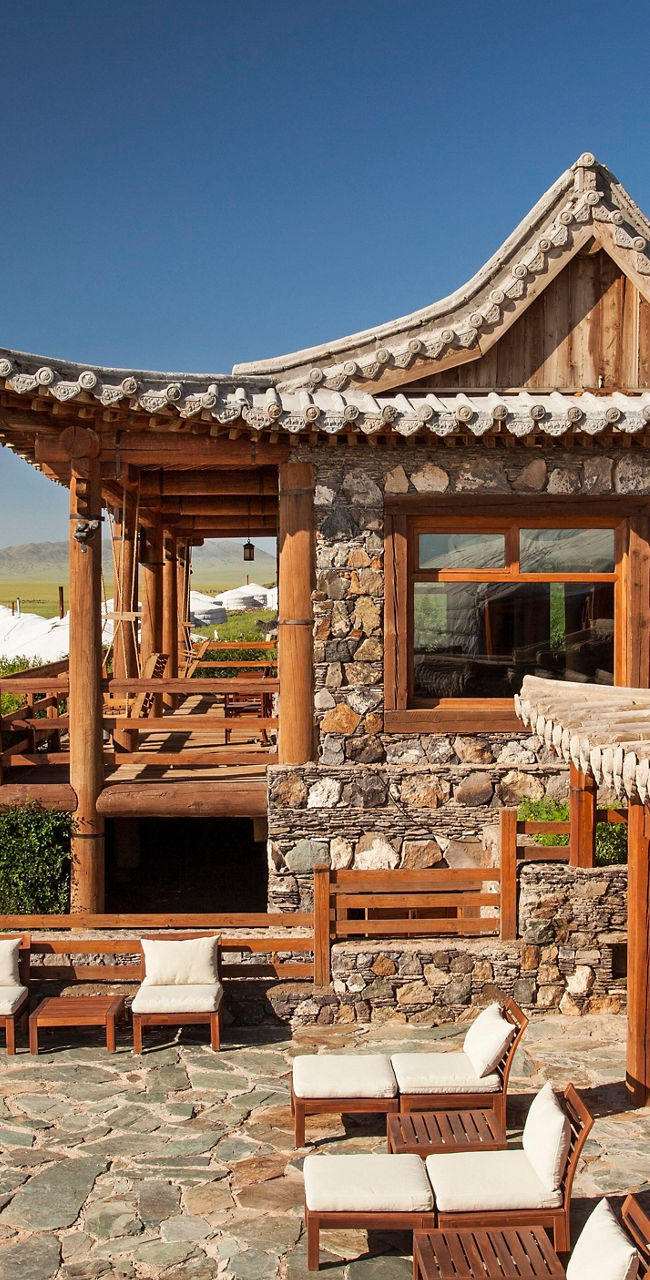Rustic lodge with yurts in open landscape