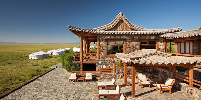 Rustic lodge with yurts in open landscape