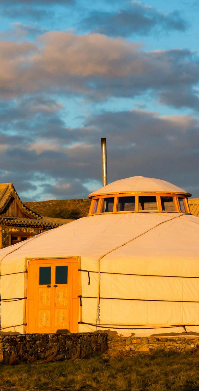 Traditional yurts in scenic sunset setting