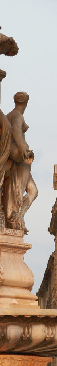 Historic fountain with classical architecture backdrop