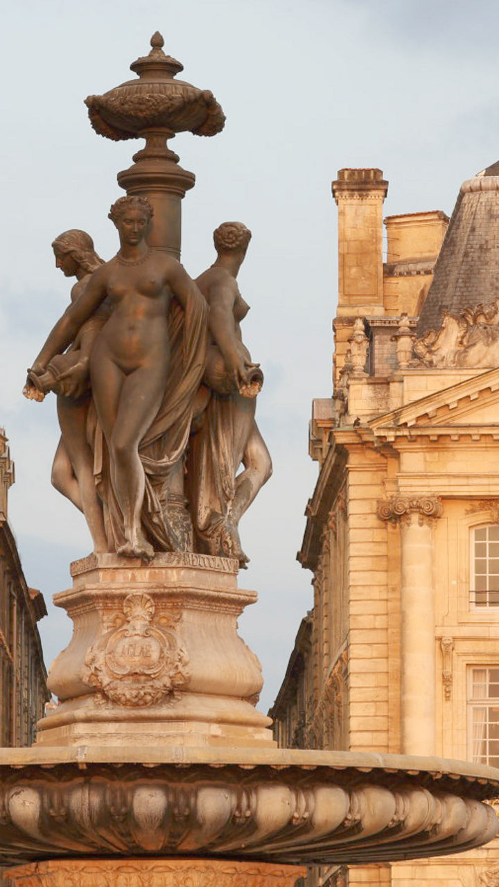 Historic fountain with classical architecture backdrop