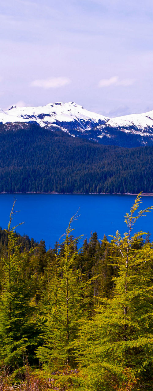 Snow-capped mountains overlooking serene blue lake