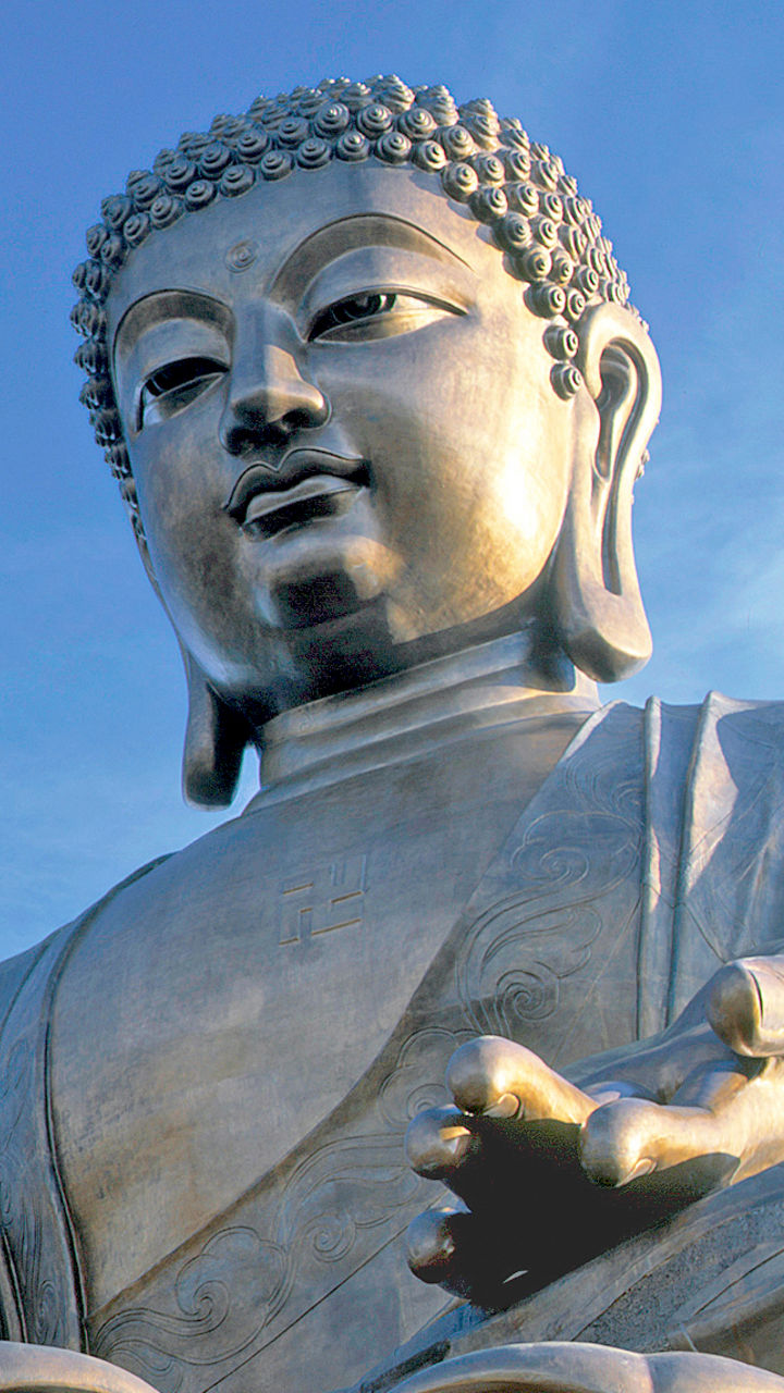 Large Buddha statue with flags outdoors