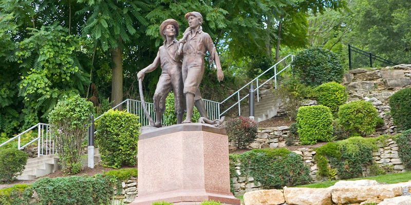 Bronze statue of two young boys outdoors