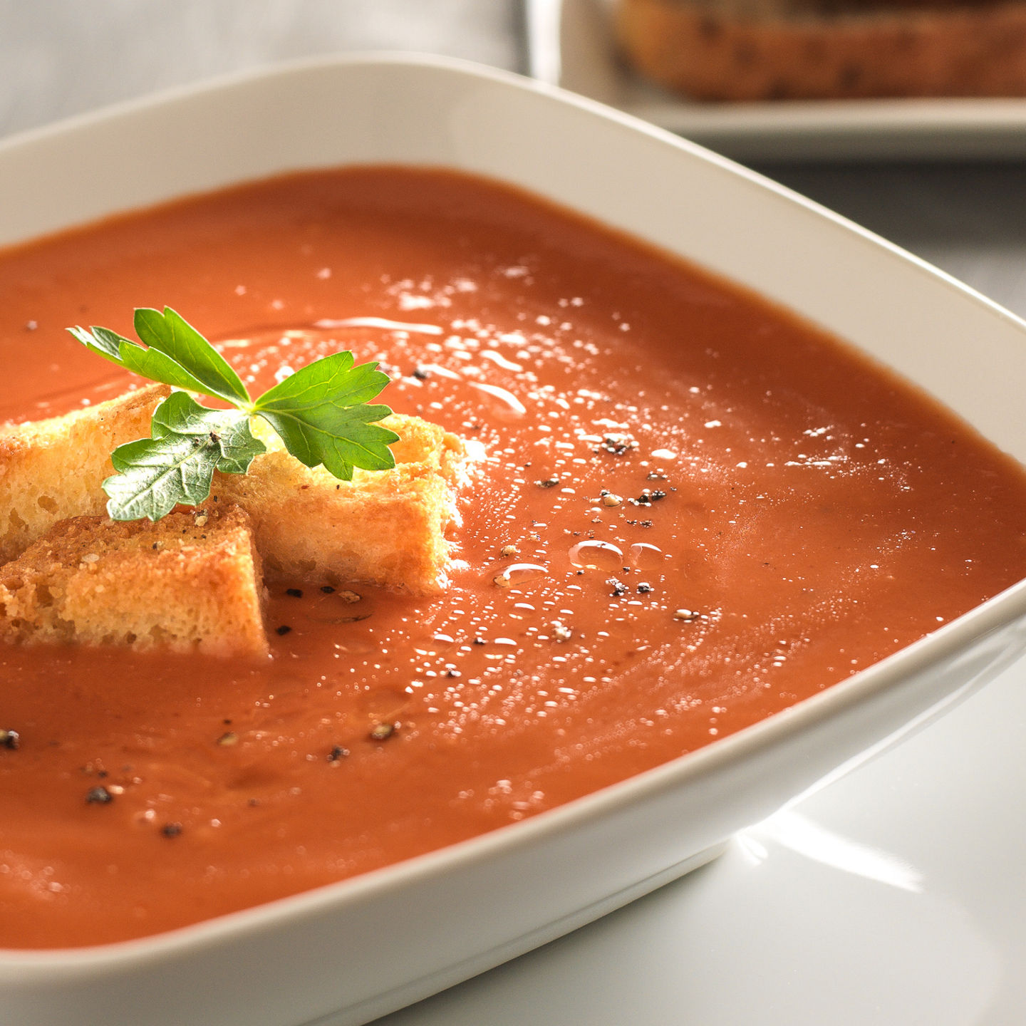 Tomato soup with croutons and bread slices
