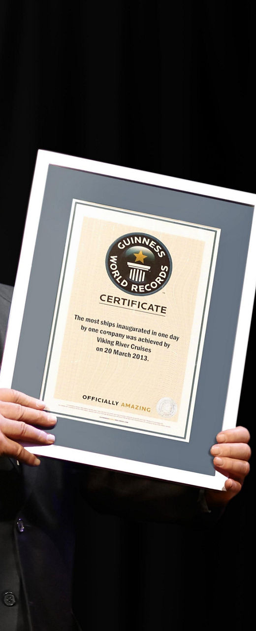 Man holding framed certificate on stage