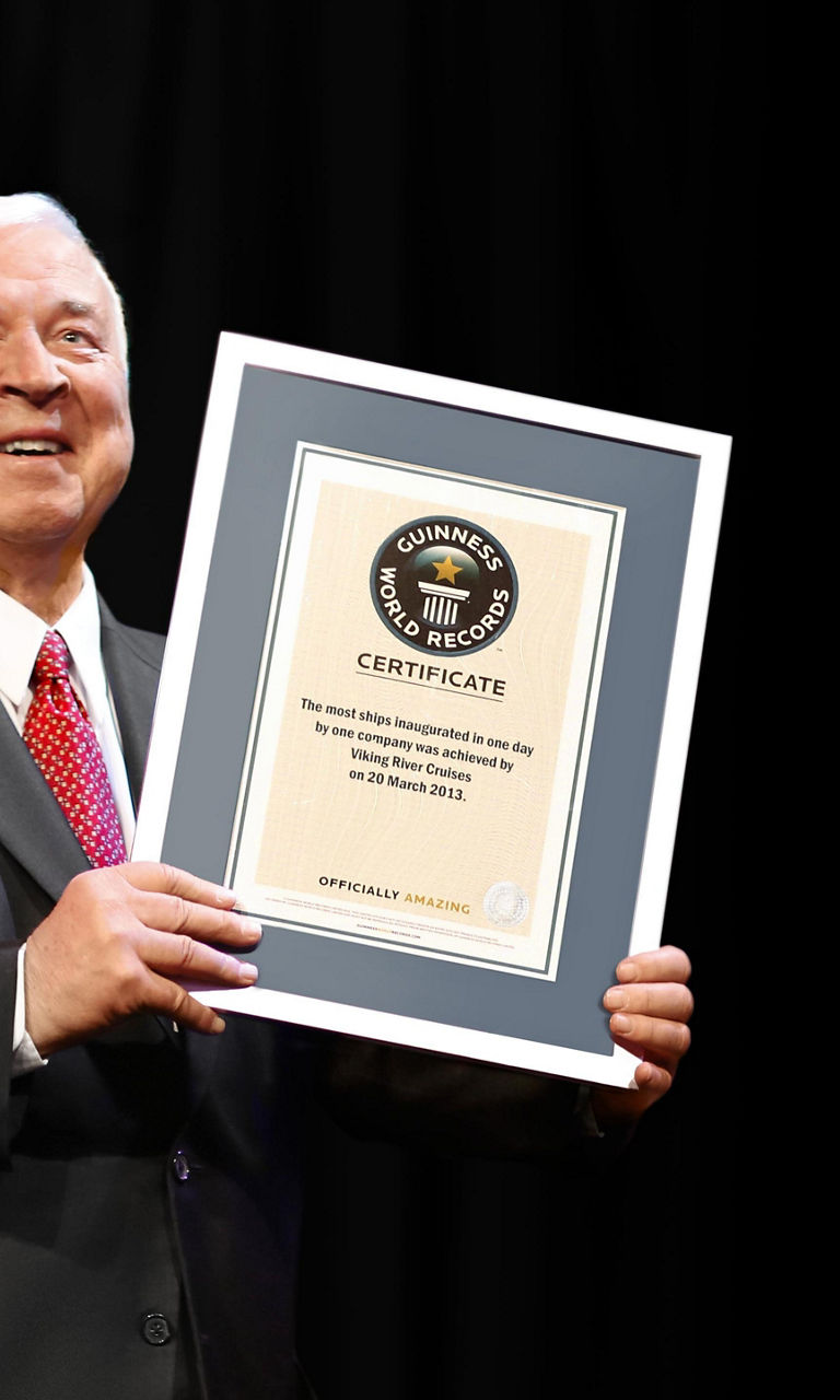 Man holding framed certificate on stage