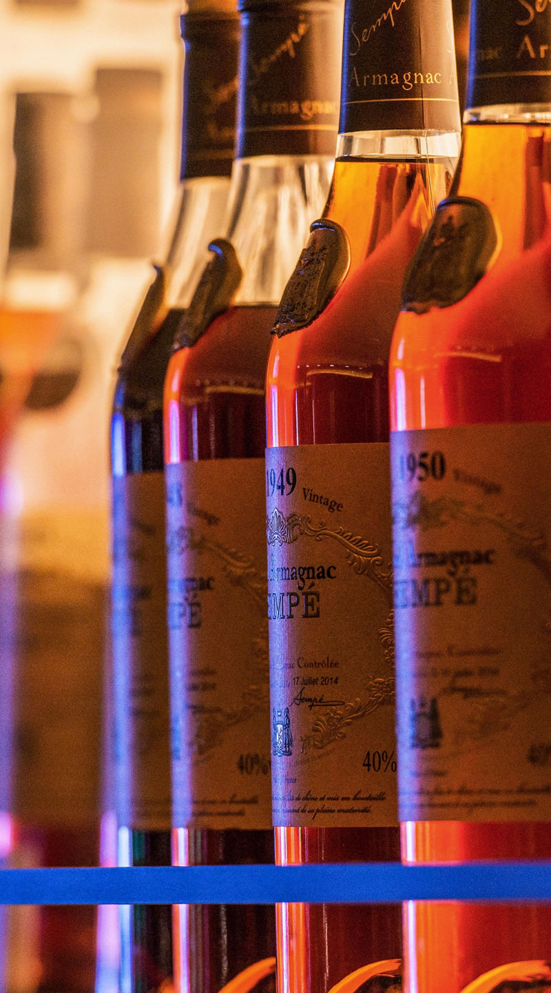 Row of amber liquor bottles on shelf