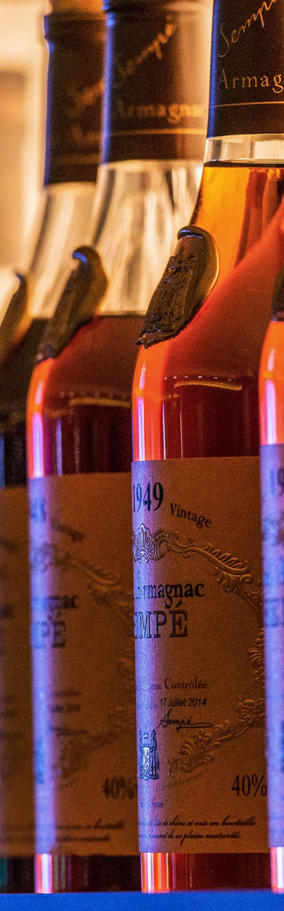 Row of amber liquor bottles on shelf
