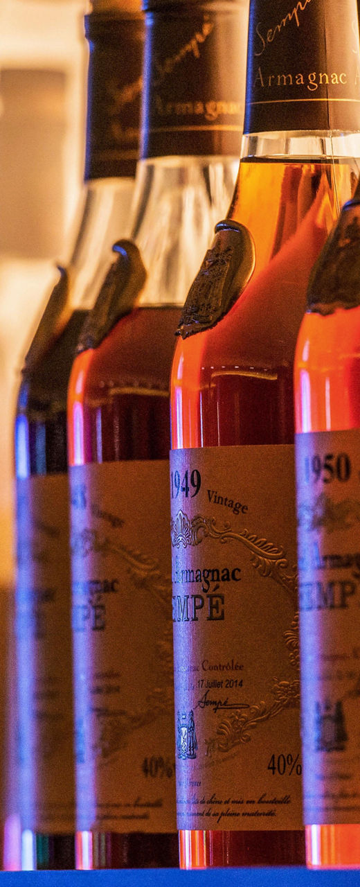 Row of amber liquor bottles on shelf