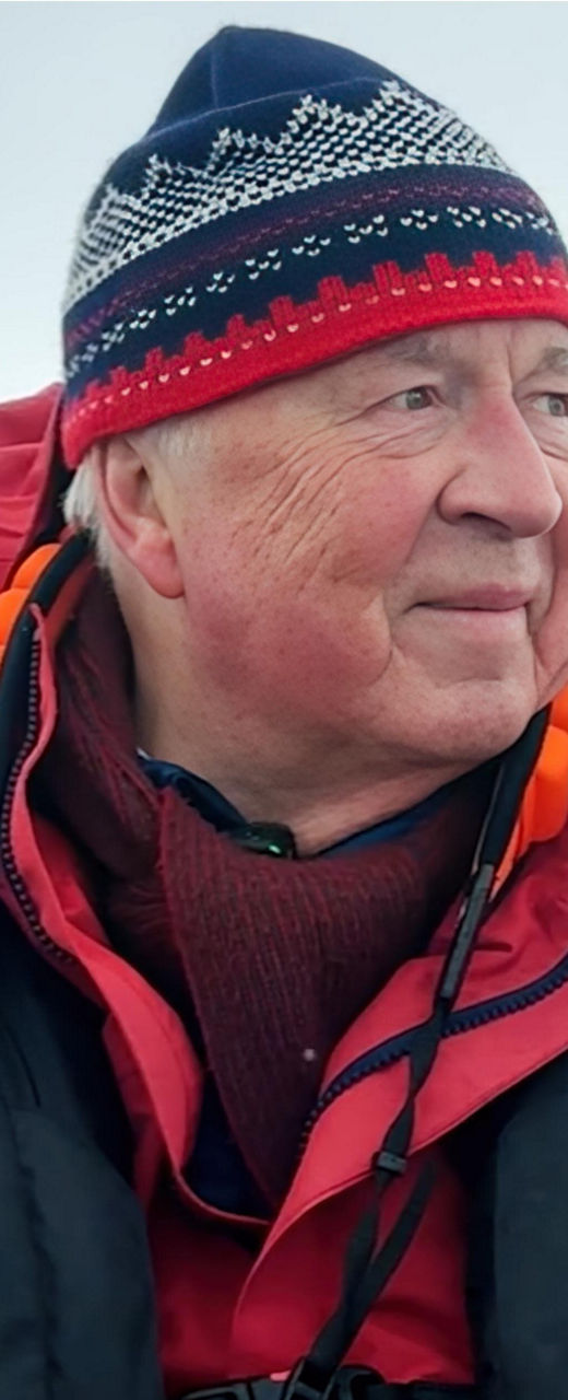 Man in red jacket exploring icy landscape