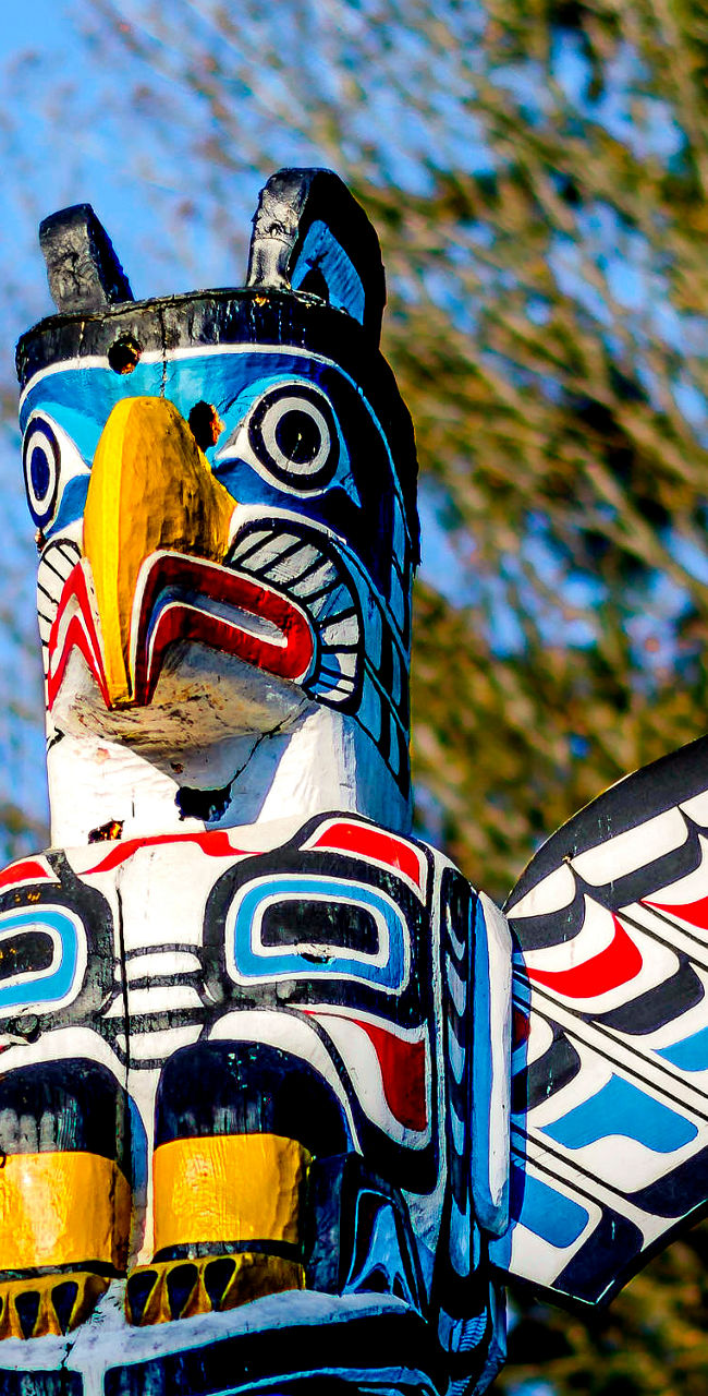 Colorful totem pole with bird design outdoors