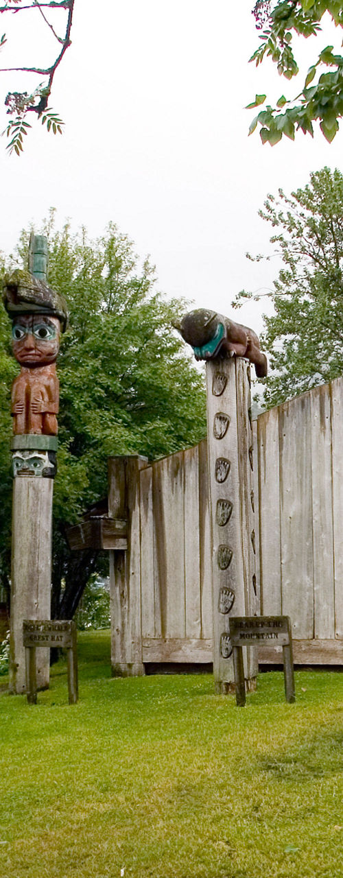 Wooden totem poles in outdoor cultural setting