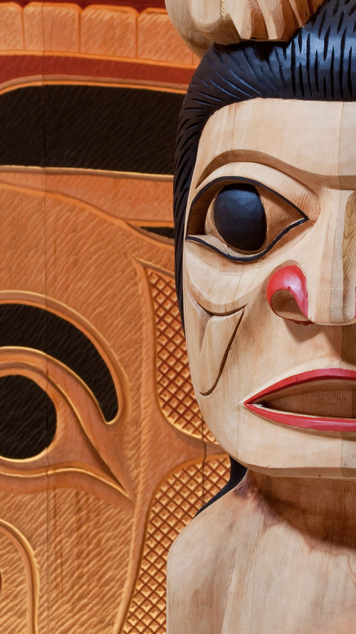 Traditional wooden totem pole carving details