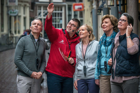 Tour guide with group in urban setting
