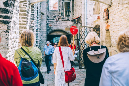 Tour group exploring historic stone alley