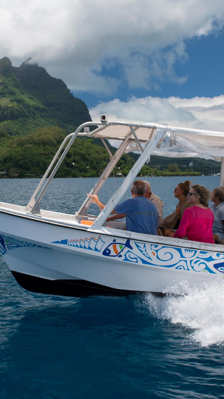 Tour boat cruising near tropical island