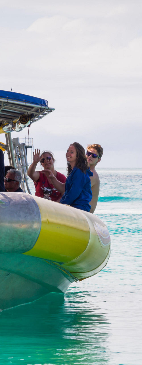 Group on yellow inflatable boat in ocean