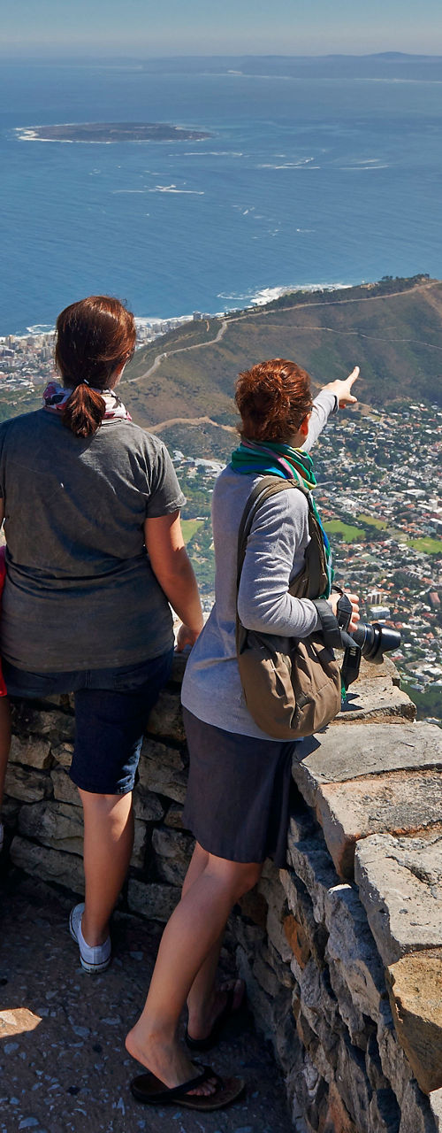 Tourists enjoying scenic view from mountain